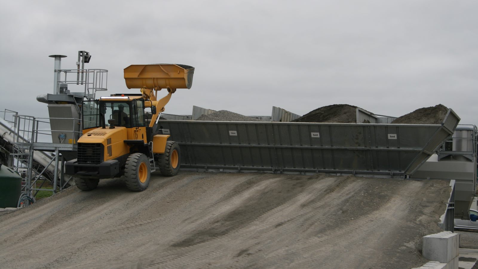 digger moving gravel for concrete